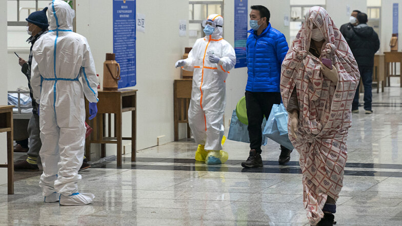 Medizinisches Personal hilft in einem provisorischen Krankenhaus in Wuhan Patienten, die sich mit dem Coronavirus infiziert haben.