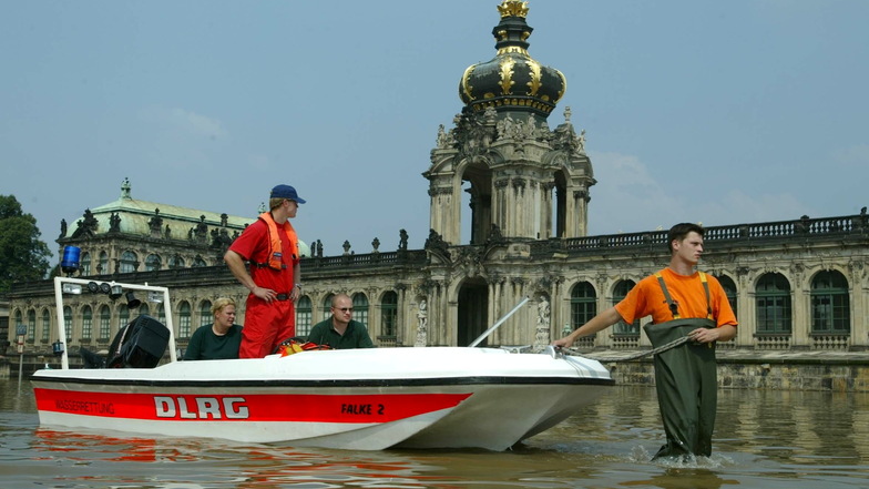 Mitarbeiter der Deutschen Lebensrettungsgesellschaft fahren mit einem Rettungsboot am Dresdner Zwinger vorbei.