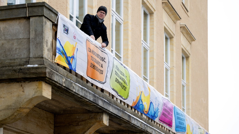 Domowina-Vorsitzender Dawid Statnik zeigt das Banner am Haus der Sorben: „Für Vielfalt, Toleranz und Demokratie“, „Ein Netzwerk für Demokratie und Vielfalt im Landkreis Bautzen“ und „Mit offenen Augen, mit offenen Ohren, mit offenen Herzen“ steht darauf.