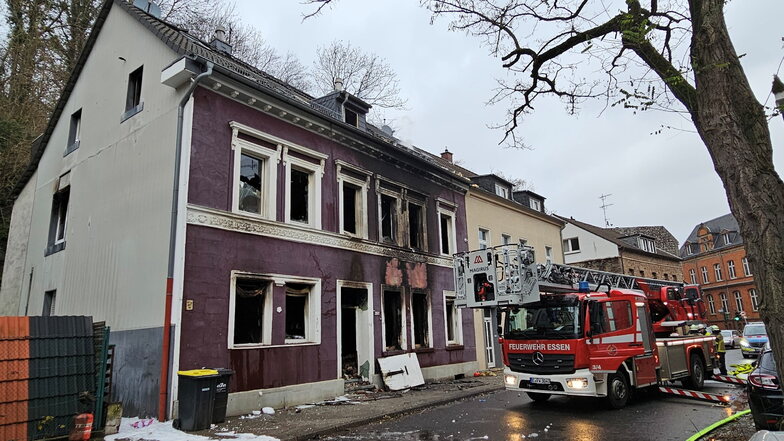 Ein Feuerwehrauto steht nach der Explosion in einem Mehrfamilienhaus vor dem zerstörten Gebäude in Essen.
