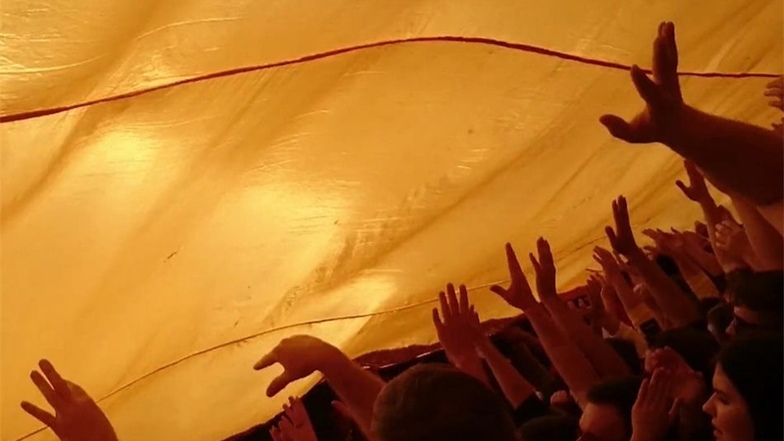 Dresden ist ... eine Fußballstadt. Dynamo-Fans jubeln unter einer schwarz-gelben Fahne.