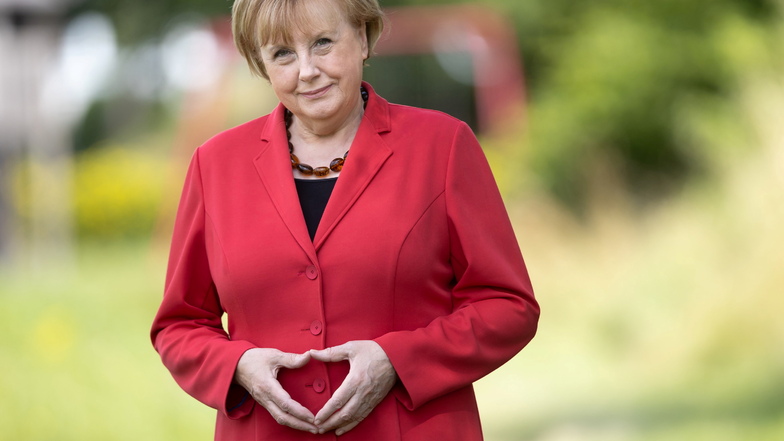 Ursula Wanecki, Doppelgängerin von Ex-Bundeskanzlerin Angela Merkel, formt mit ihren Händen eine Raute.