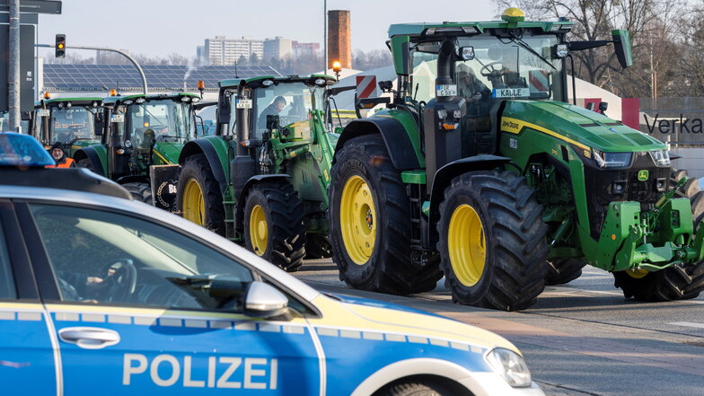 Traktoren, Lkw und Transporter blockieren am Montagvormittag auf einer Bundesstraße in Pirna in beiden Richtungen jeweils eine Spur. Die Polizei beobachtet die Aktion.