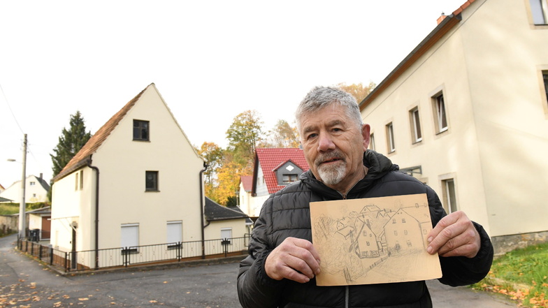 Volkmar Kreh mit seinen alten Zeichnungen von Freital-Burgk. Im Haus rechts im Bild wohnte er bis 1968.