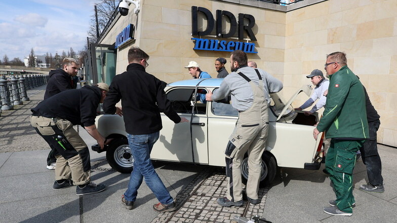 Ein Trabant wird eine Rampe zum DDR Museum hinunter gerollt, das nach dem Wasserschaden wieder öffnet.