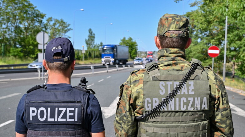Ein deutscher Polizist und sein polnischer Kollegen stehen am Autobahngrenzübergang am Gemeinsamen Zentrum der Deutsch-Polnischen Polizei- und Zollzusammenarbeit in Swiecko.