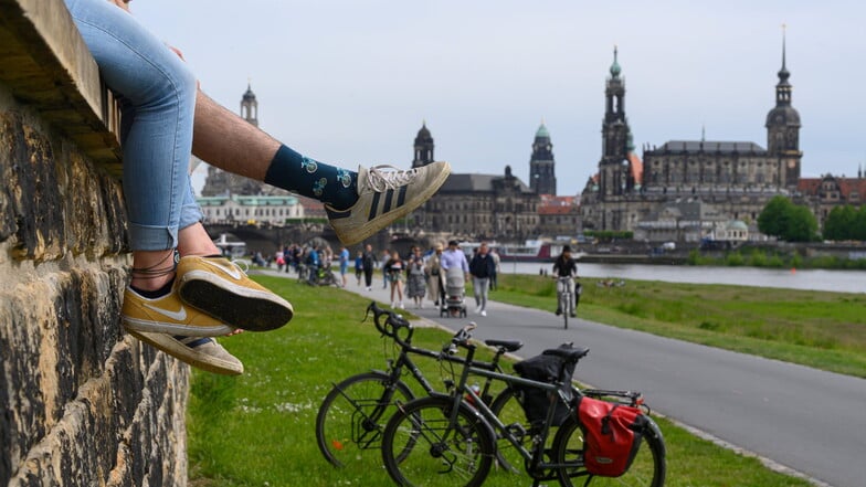 Passanten und Radfahrer genießen auf dem Elberadweg in Dresden das Pfingstwochenende.