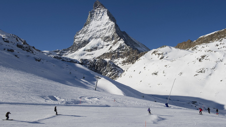 Zermatt: Skifahrer fahren die Pisten am Riffelberg mit dem Matterhorn im Hintergrund hinunter.