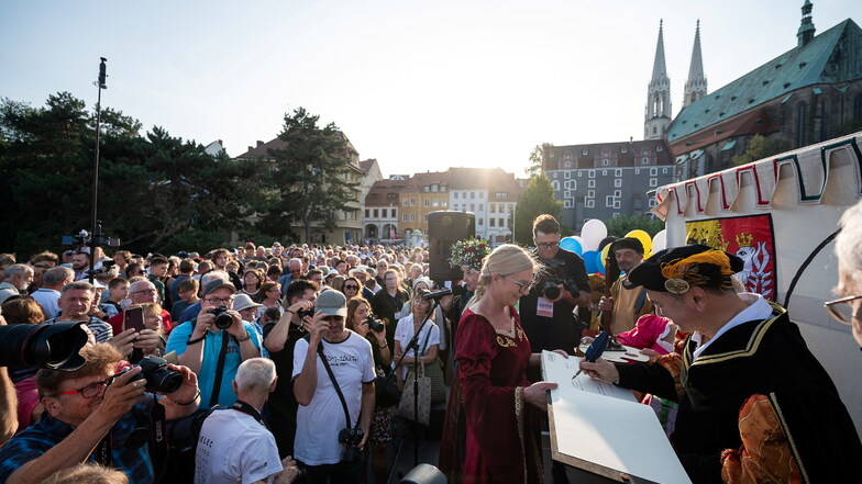 Octavian Ursu(rechts) unterschrieb in einem großen Buch auf der Altstadtbrücke zur Eröffnung des Görlitzer Altstadtfestes.