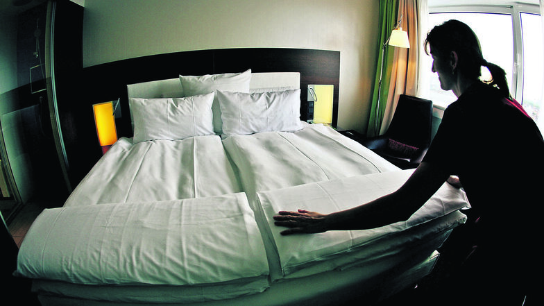 Ein Zimmermädchen macht in einem Hotelzimmer das Bett. Die Übernachtung in Gästebetten ist durch die Taxe seit dem 1. Januar in Meißen teurer geworden.