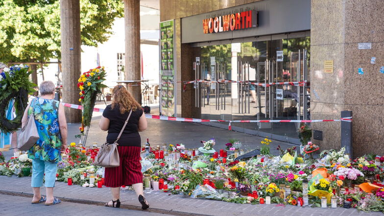 Würzburg: Trauerkerzen und Blumen liegen vor einem Kaufhaus in der Innenstadt, in dem der Täter Menschen mit einem Messer attackiert und drei Frauen getötet hat.