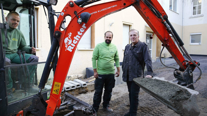 Daniel Mücklich und Benjamin Richter (v.l.) von der Landschaftsbaufirma treffen sich mit Tom Schurig auf dem Gelände des Jugendtreffs zur Baubesprechung.