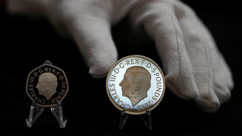 Zwei neue Münzen mit dem offiziellen Münzporträt von König Charles III., links die neue 50-Pence-Münze und rechts die neue 5-Pfund-Gedenkmünze, die zu den ersten Münzen mit dem Portrait des neuen Königs gehören werden.