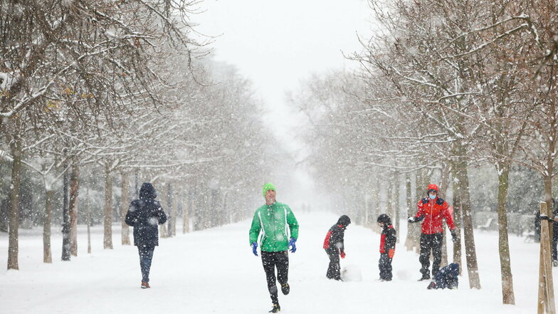 Ein Mann joggt im Schnee im Retiro-Park in Madrid.
