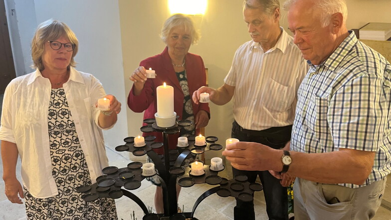 Dr. Anna Kaminsky von der Bundesstiftung zur Aufarbeitung der SED-Diktatur (l.) zündet in der Großenhainer Marienkirche mit der IG Mahnmal Erinnerungskerzen an.