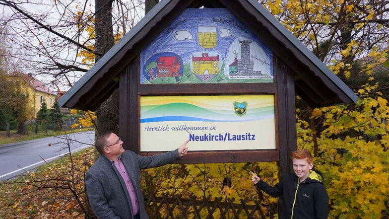 Bürgermeister Jens Zeiler und Schüler Richard Hartmann haben die dieser Tage die neue Ortseingangstafel auf der Straße von Putzkau nach Neukirch enthüllt.