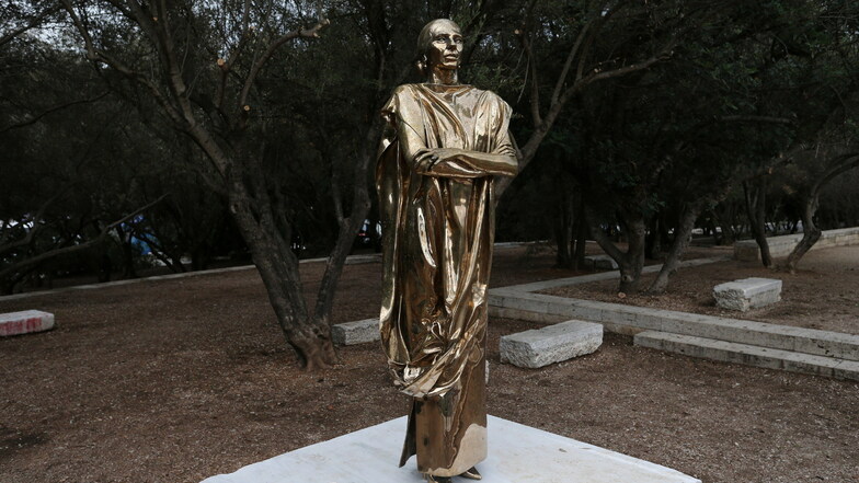 Eine Bronzestatue der legendären Sopranistin Maria Callas steht gegenüber dem Odeon des Herodes Atticus in einem kleinen Park mit Olivenbäumen in der Nähe der Akropolis von Athen.