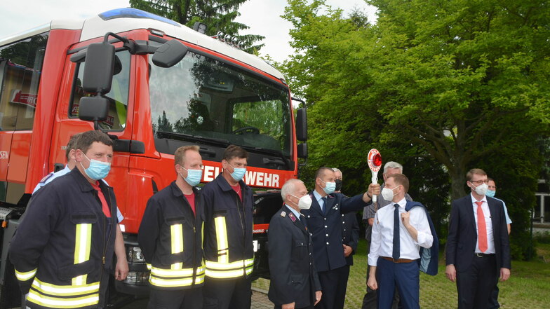 Gruppenfoto der Feuerwehr Friedersdorf mit Ministerpräsident, Bürgermeister (verdeckt), Innenminister und neuem Fahrzeug.