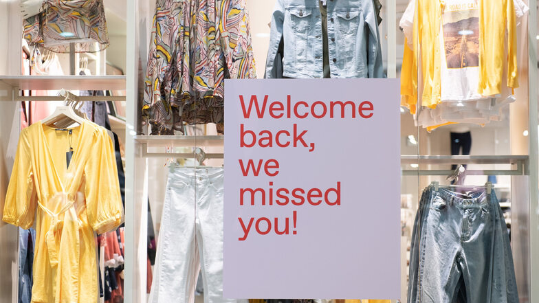 Ein Schild mit der Aufschrift "Welcome back, we missed you" hängt in der Dresdner Altmarkt-Galerie in einem Schaufenster
