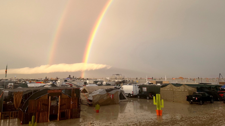 Ein Regenbogen ist über dem matschigen Gelände des Burning-Man-Festivals zu sehen.