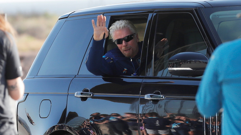 Richard Branson winkt auf dem Weg zu dem Raumflugzeug "VSS Unity aus einem Auto