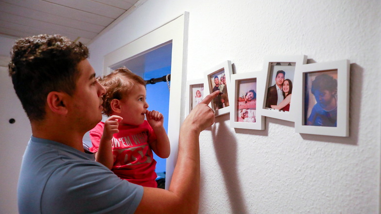 Papa Jesus schaut mit Töchterchen Laura Familienbilder an.