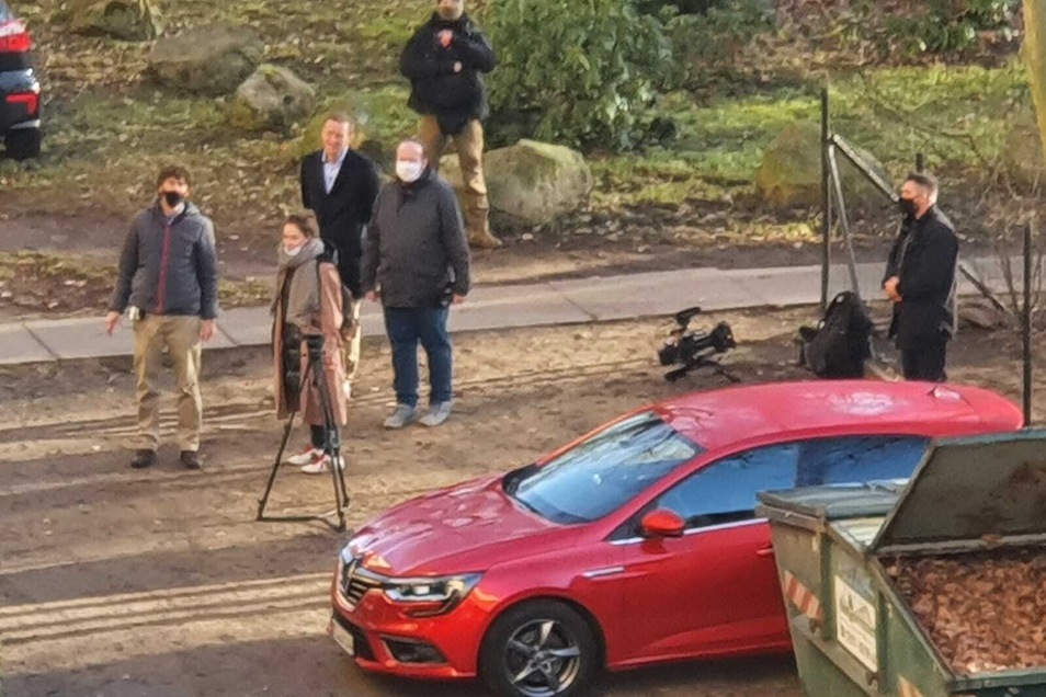 A camera team accompanies Navalny (black jacket, center) on his visit.